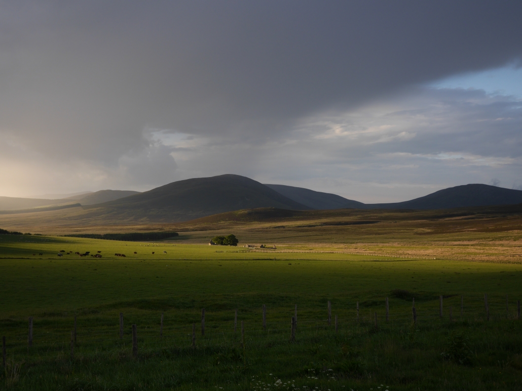 The view from Ghillie's house, looking onto a sunlit and empty valley